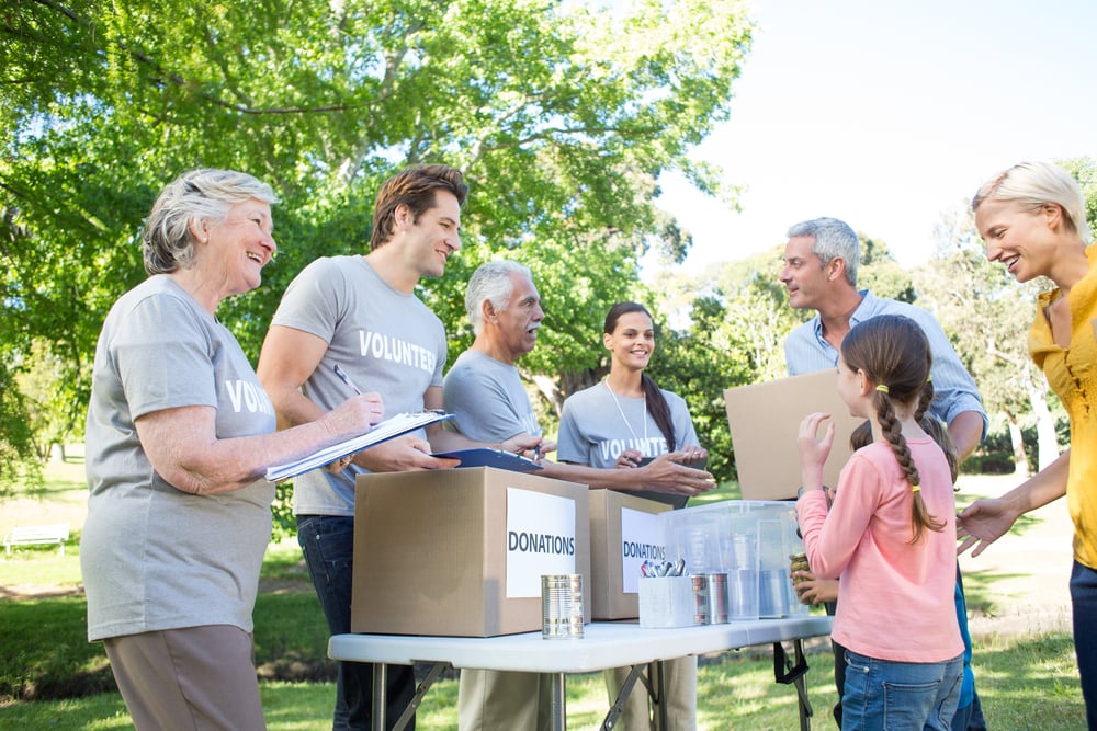 Happy volunteer family separating donations stuffs on a sunny day-1